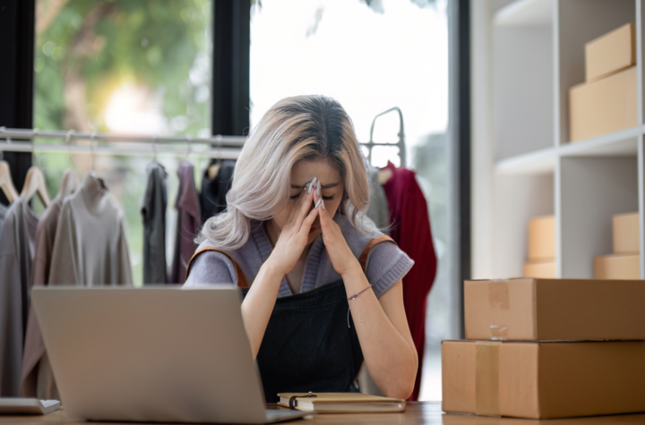 Stress serious asian woman doing clothing business selling online making business credit mistakes. she using laptop computer. online